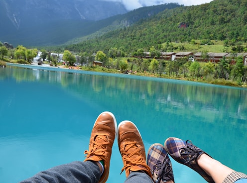 two persons wearing shoes during day