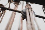 Close-up of industrial rope maintenance work on a factory structure.