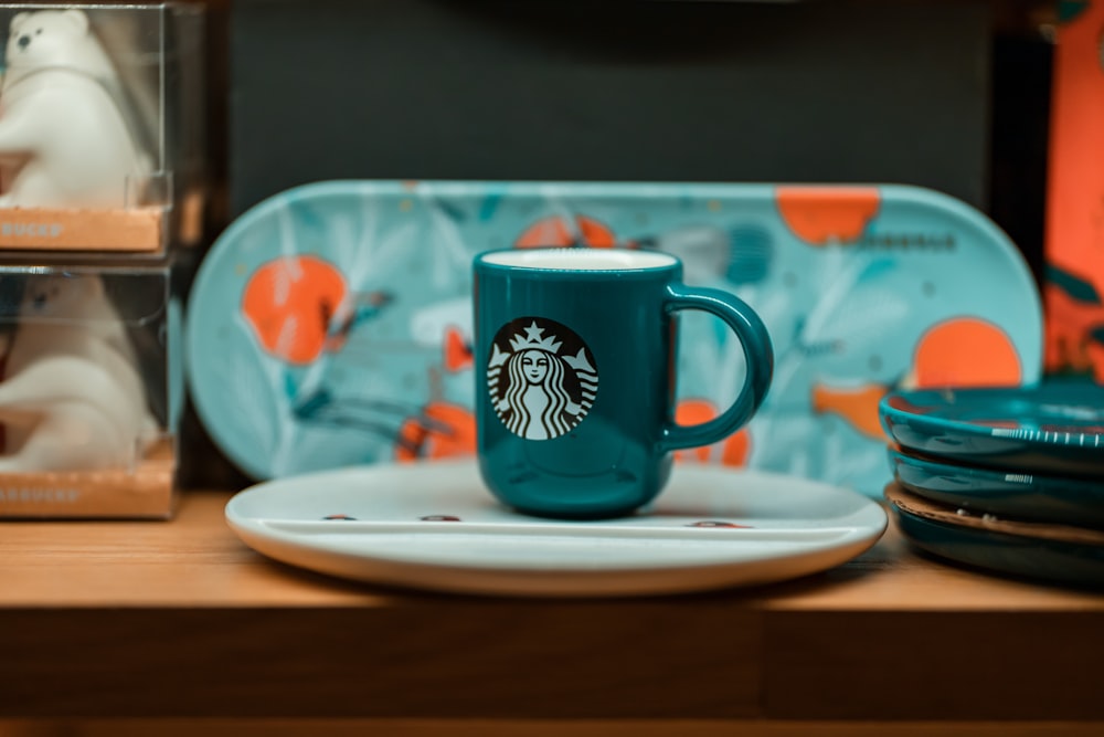 green Star Bucks ceramic mug on plate