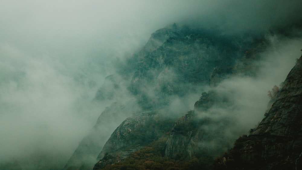 a mountain covered in fog and low lying clouds