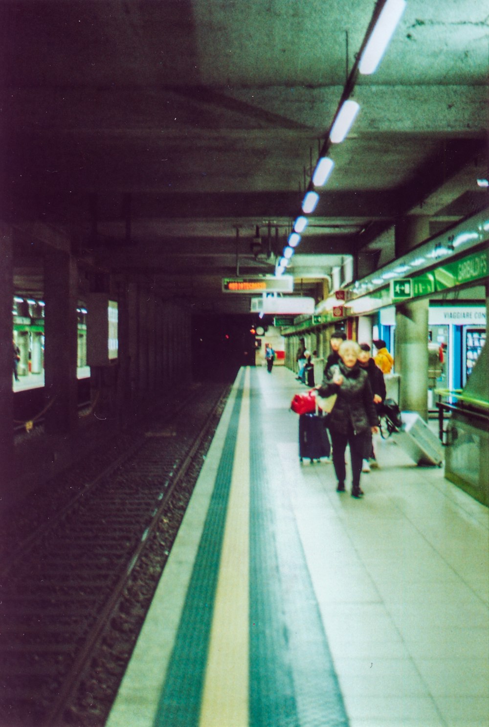 people walking beside train track