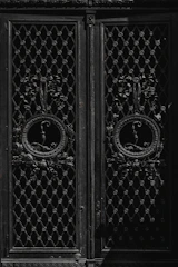 Architectural metal doors with intricate designs ready for installation.