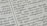 Close-up of a page with Tamil script written in neat black letters, showing two columns of text. The focus is on the middle area, with surrounding text slightly blurred.