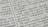 Close-up of a page with Tamil script written in neat black letters, showing two columns of text. The focus is on the middle area, with surrounding text slightly blurred.