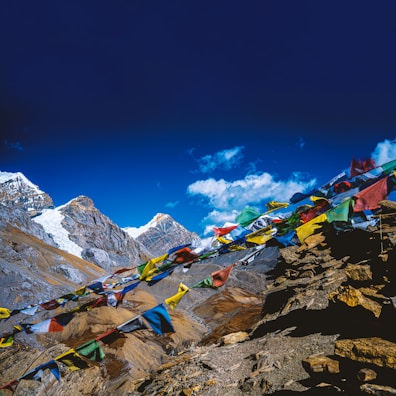 Colorful prayer flags fluttering against a backdrop of majestic peaks.