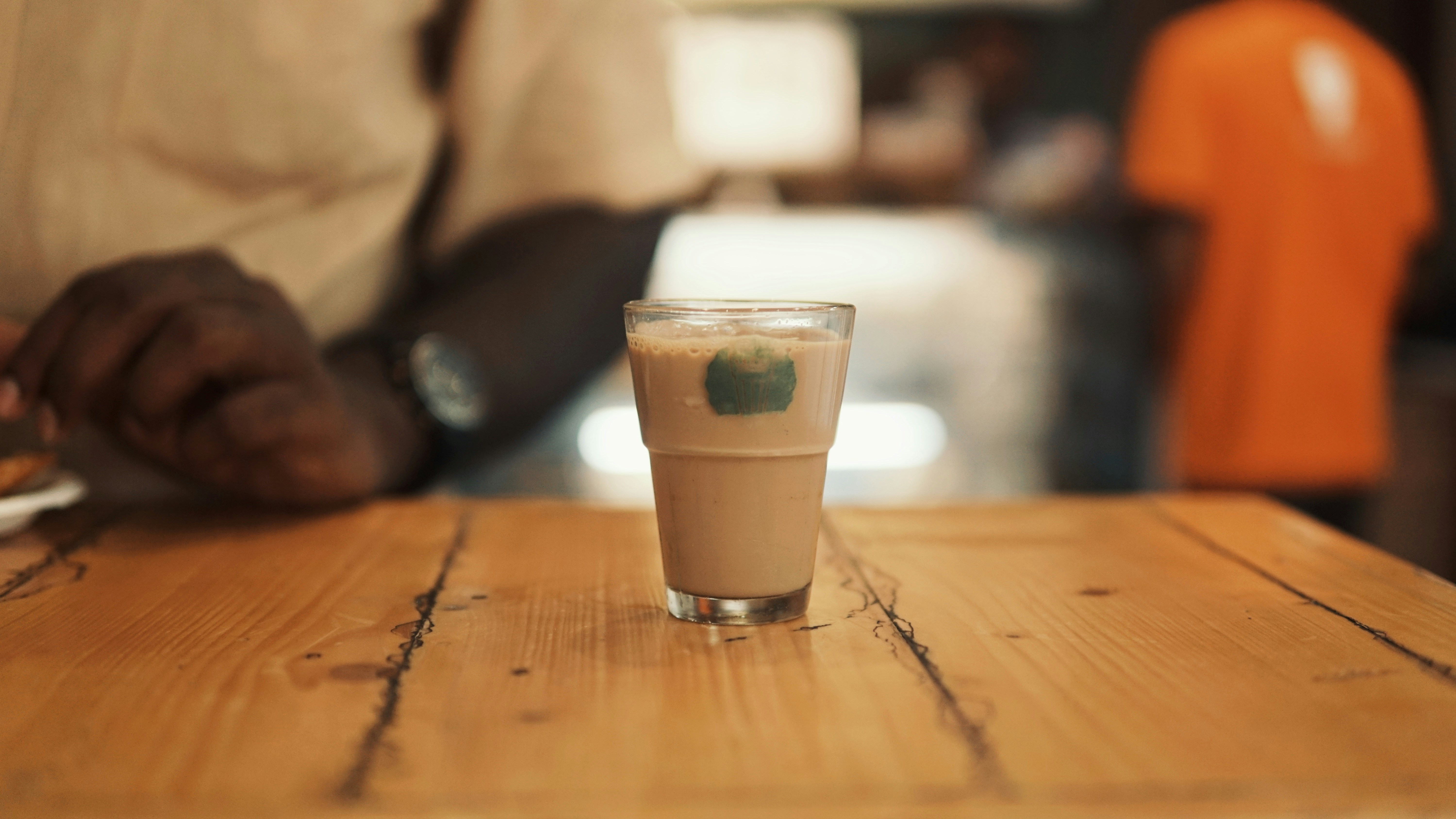 Glass of coffee on a timber table