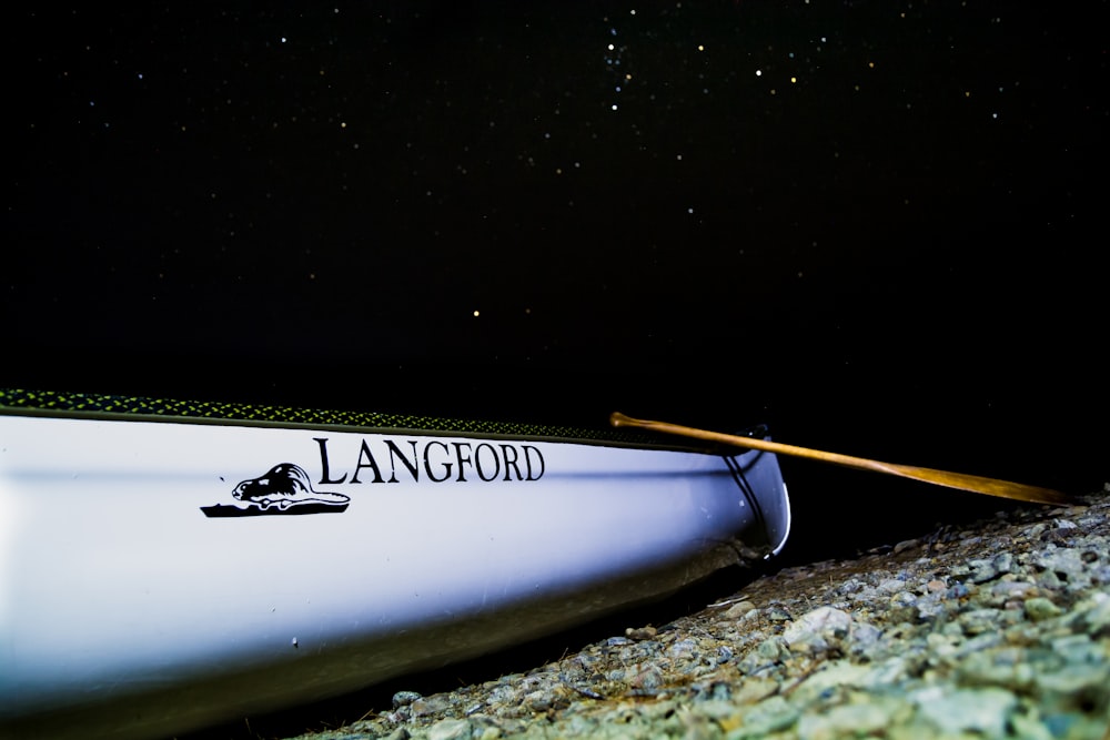 white Langford rowboat on shore