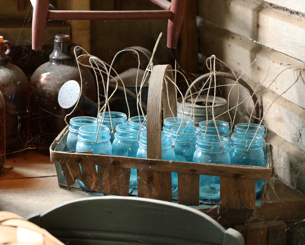 blue glass mason jars on brown wooden basket