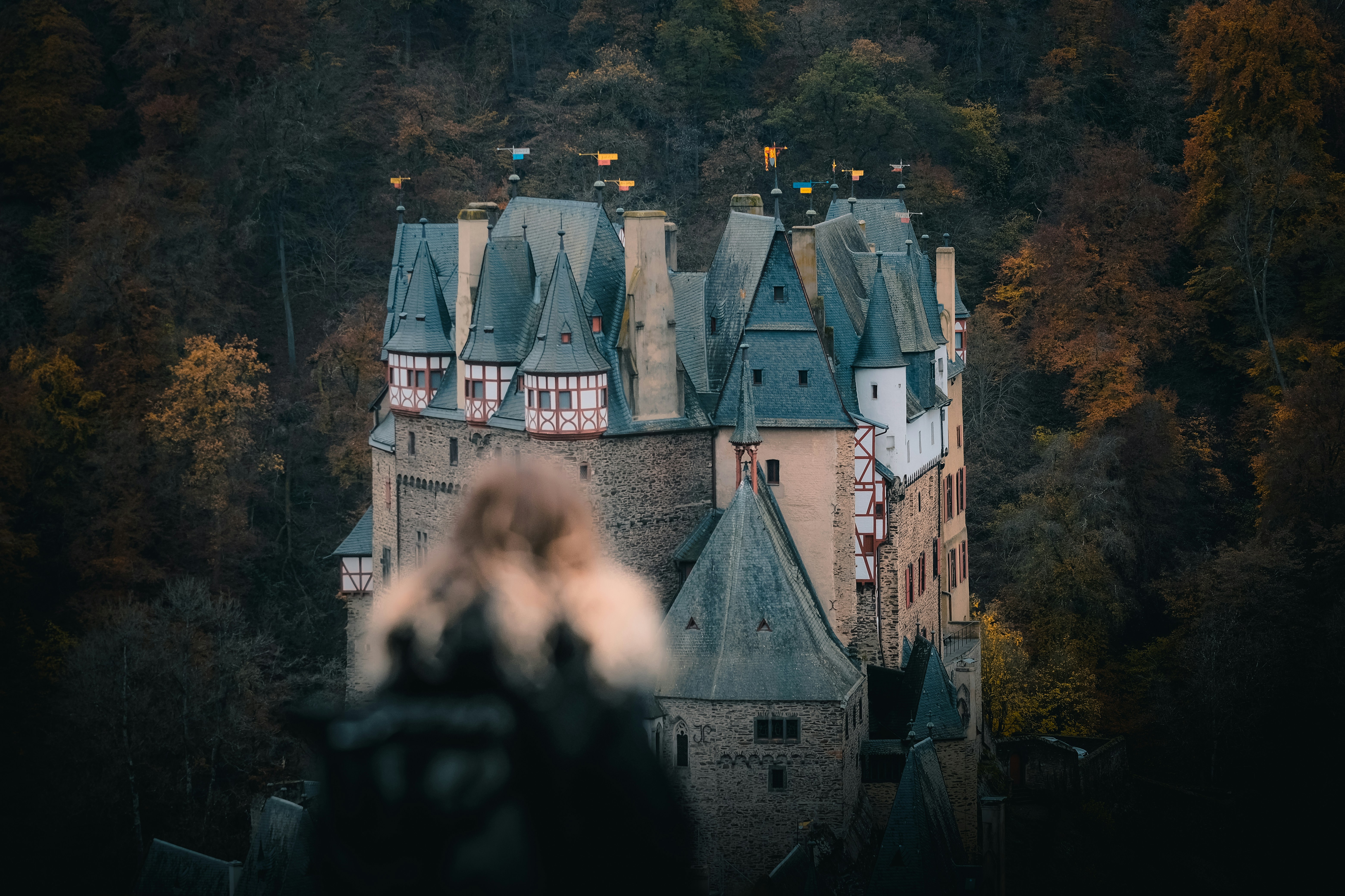 person standing in front of gray concrete castle