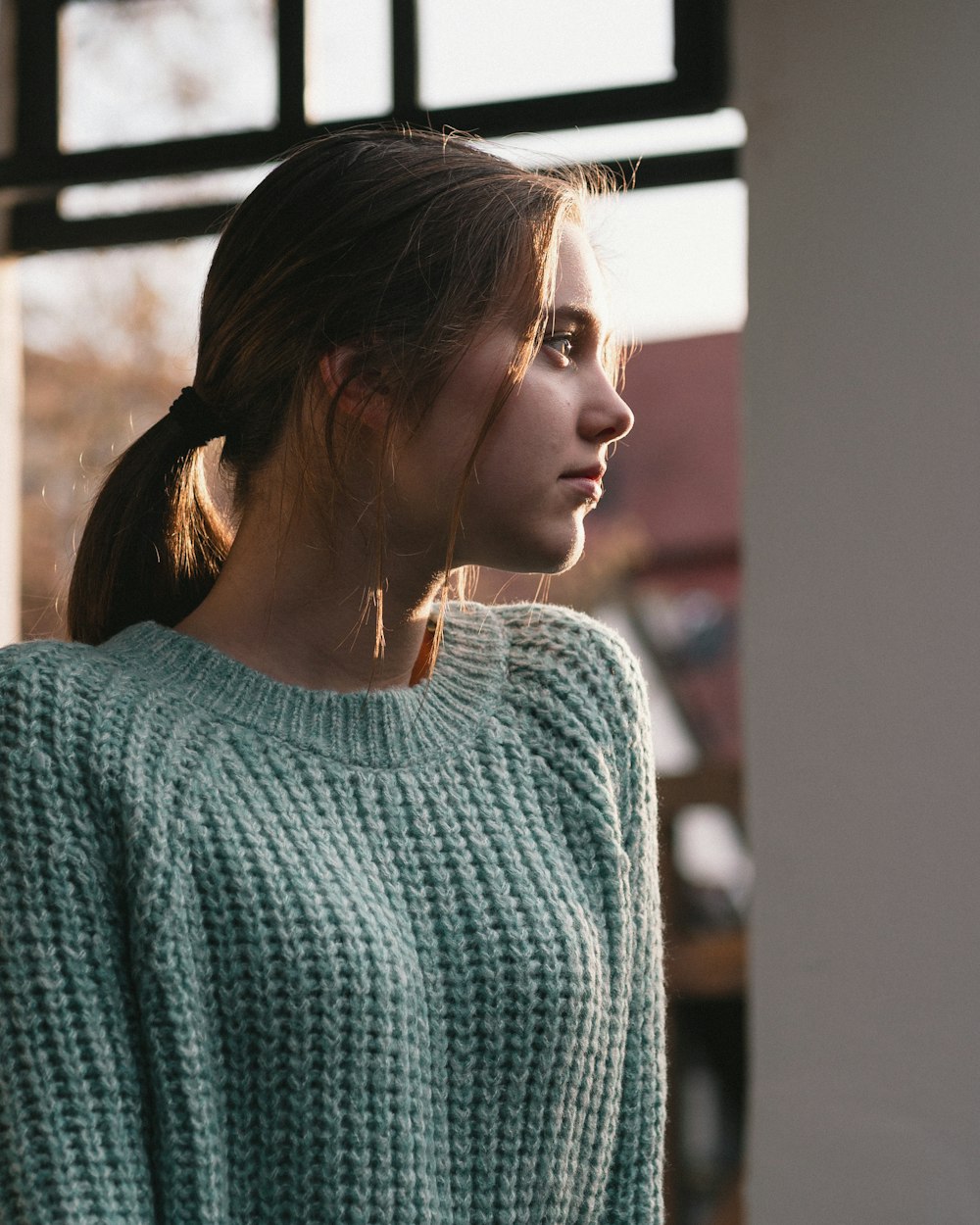 woman wearing grey knit sweater during daytime