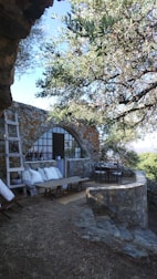 A completed stone patio showcasing intricate masonry work in a backyard.