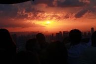 A sunset view of the Columbus skyline behind a group celebrating a successful event.