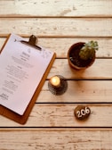 A boho-inspired menu holder made from warm-toned solid wood on a café table.