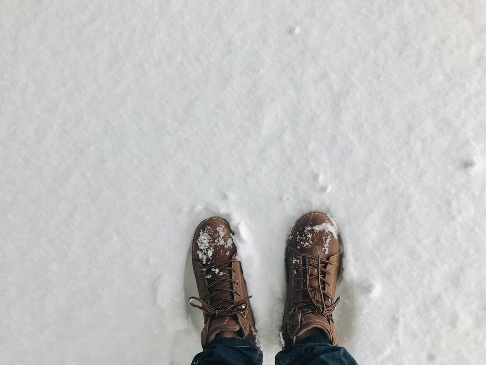 person wearing brown snow boots