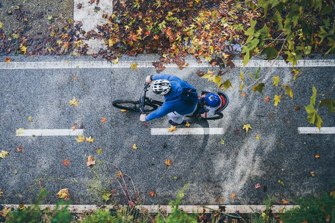 man riding bike on road