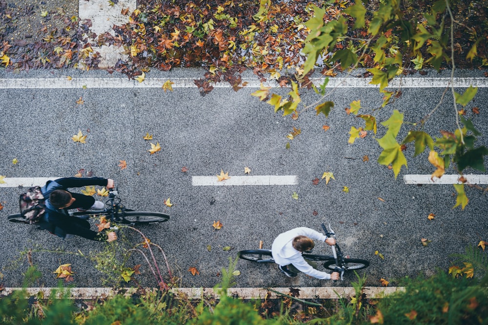 aerial photography of man riding bike on streets