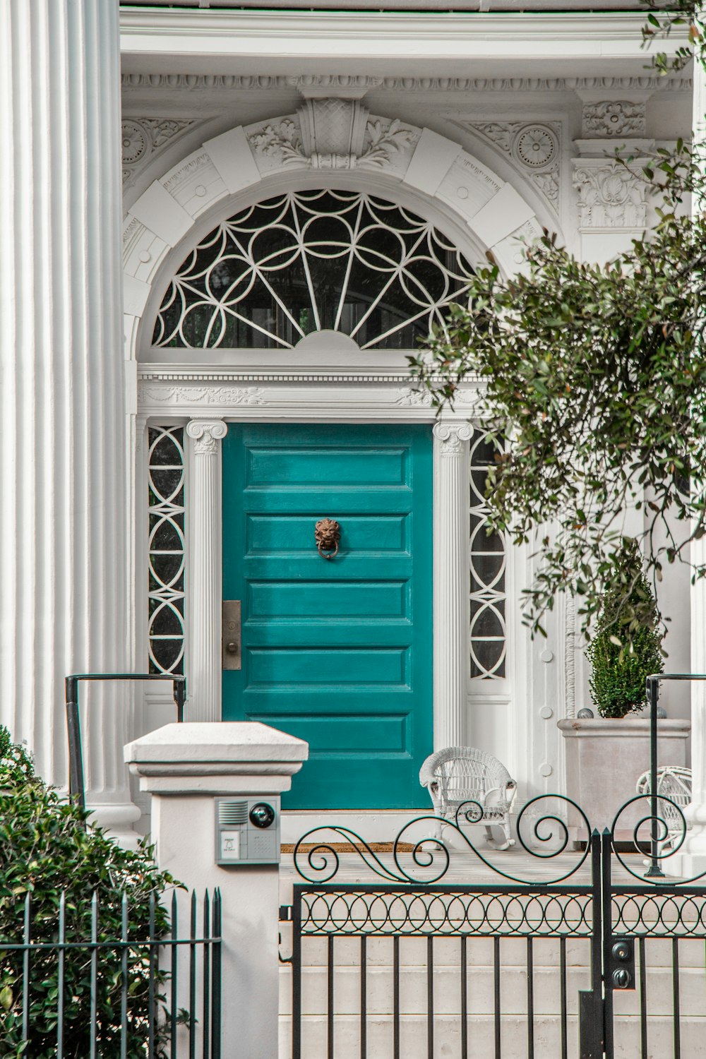 white building showing closed green wooden door