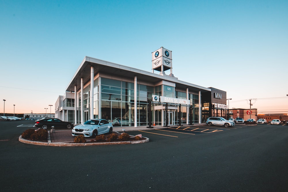 different vehicles near glass walled building