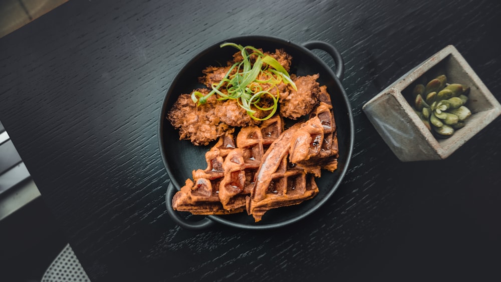 waffle near fried food in black pot near green succulent plant