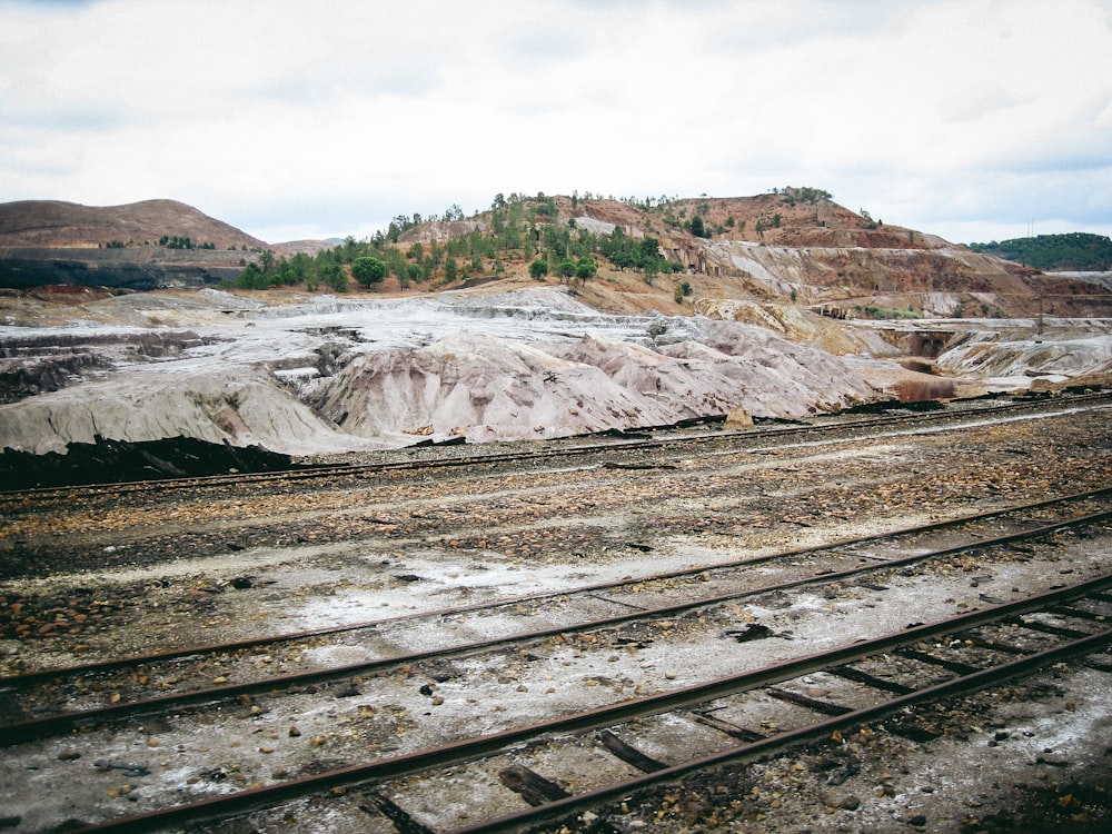 a train track with a mountain in the background