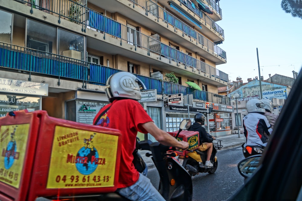 person riding motor scooter during daytime