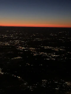 A stunning aerial shot capturing the vibrant cityscape of Idlib at sunset, showcasing both natural beauty and urban life.