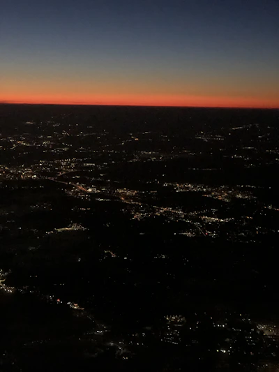 A stunning aerial shot capturing the vibrant cityscape of Idlib at sunset, showcasing both natural beauty and urban life.