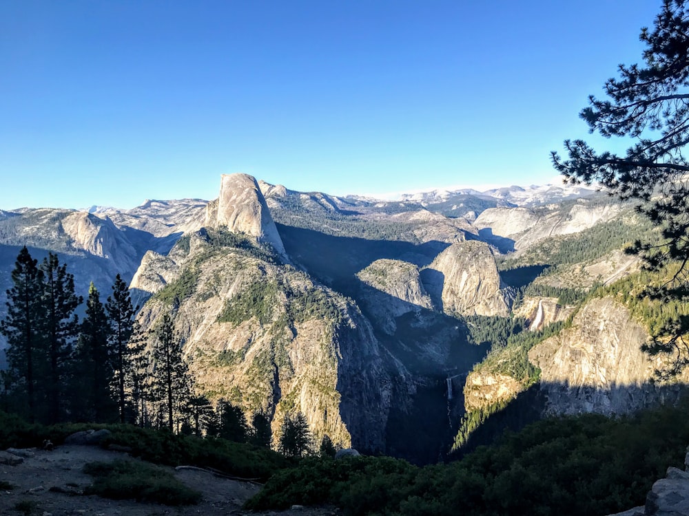 selective focus photography of mountains under blue sky