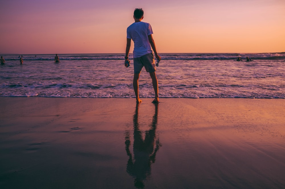 man standing in front of seashore