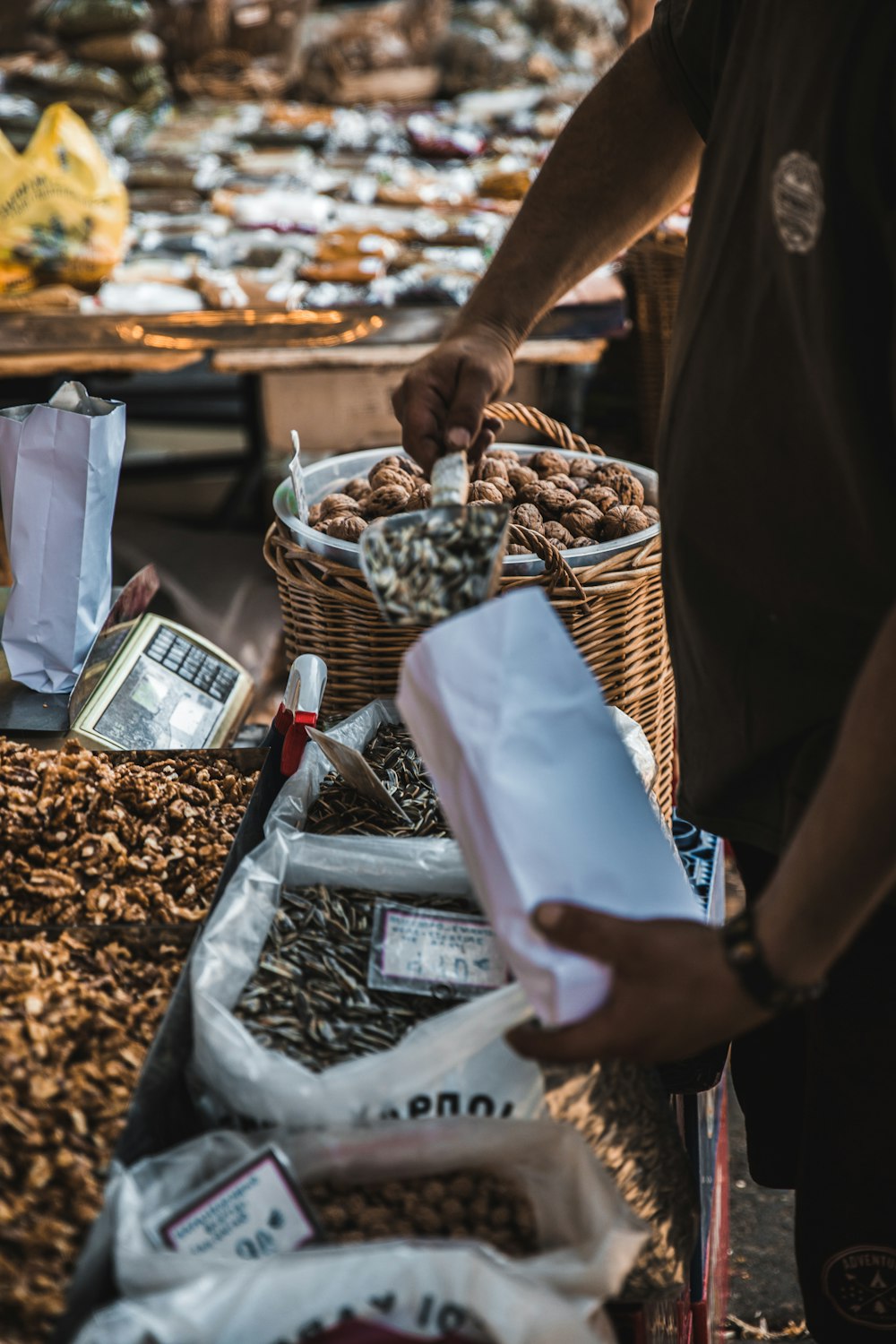 person putting seeds on paper pack