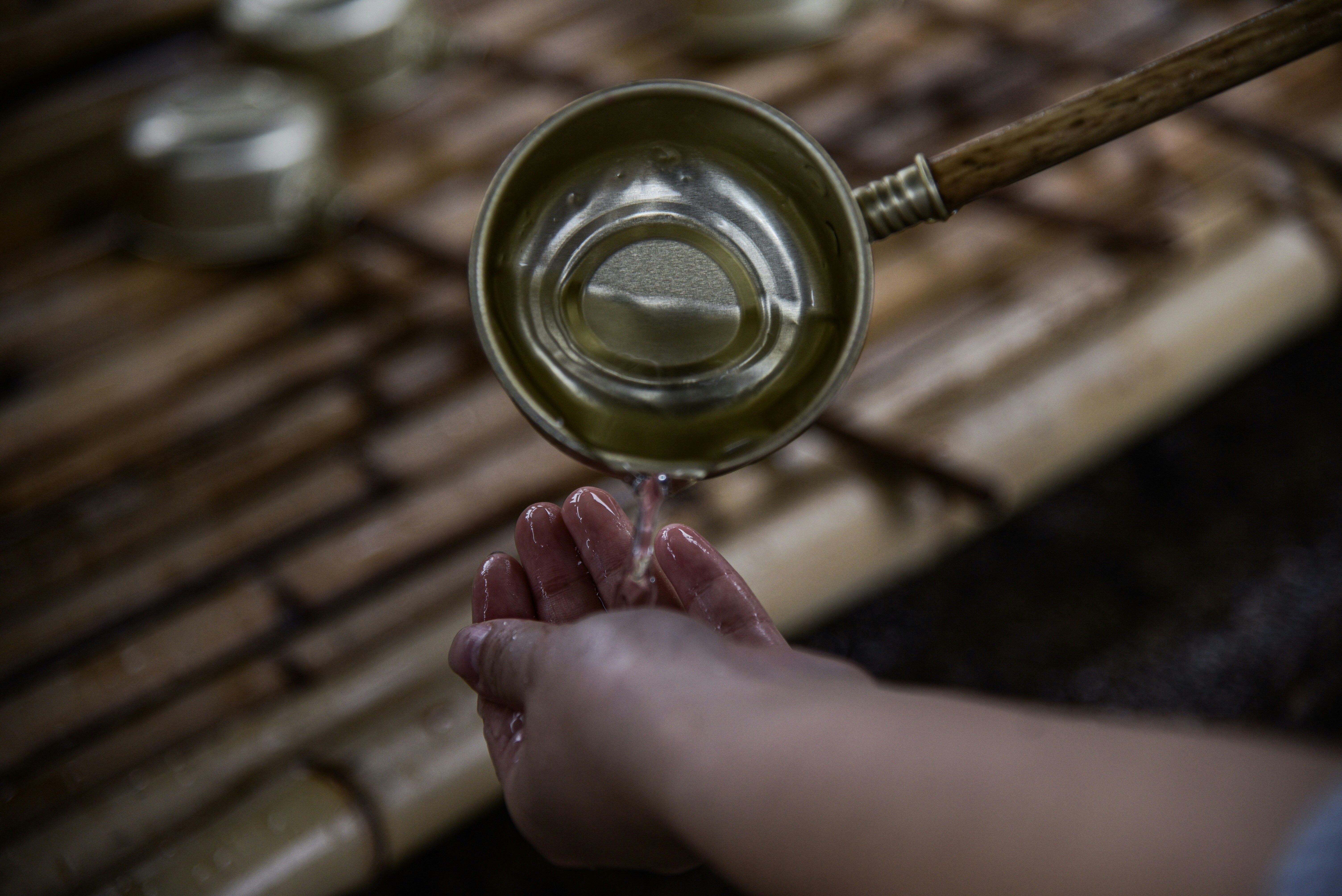 person pouring water on hand