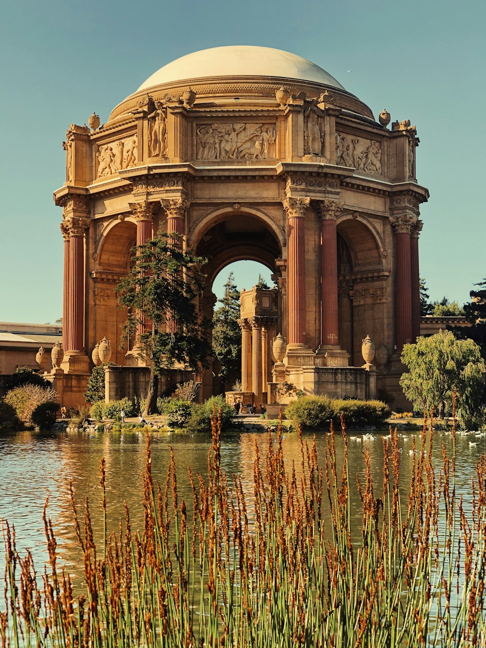 brown concrete gazebo surrounding with water