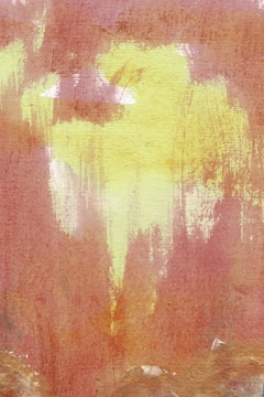 Abstract art featuring soft, flowing brushstrokes with a blend of earthy reds and vibrant yellows. The texture appears rough, resembling watercolor or grunge textures, creating a sense of fluidity and motion.