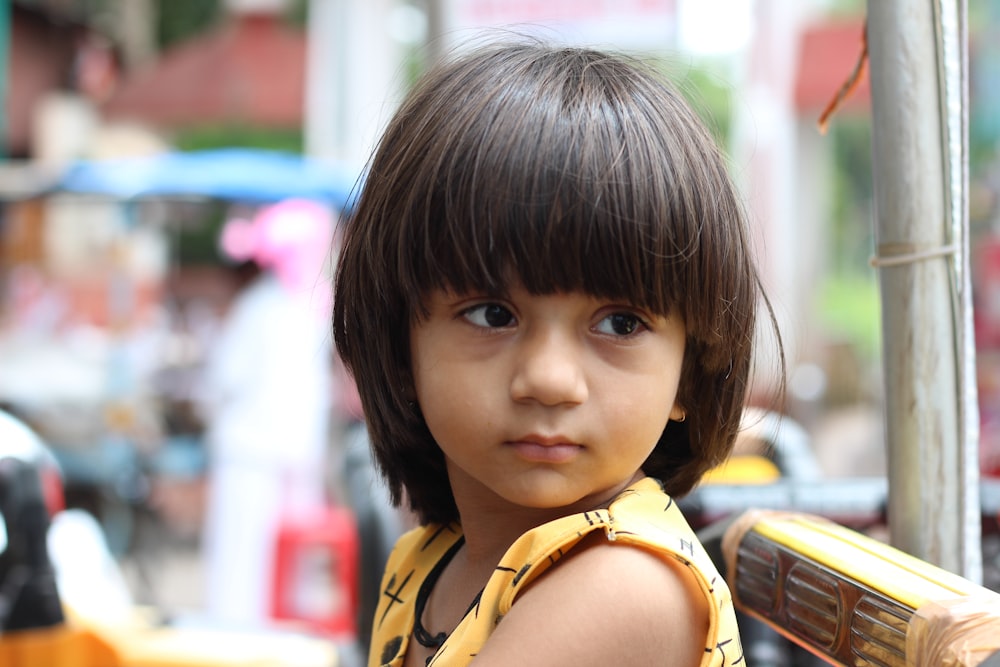 girl wearing yellow and black striped shirt