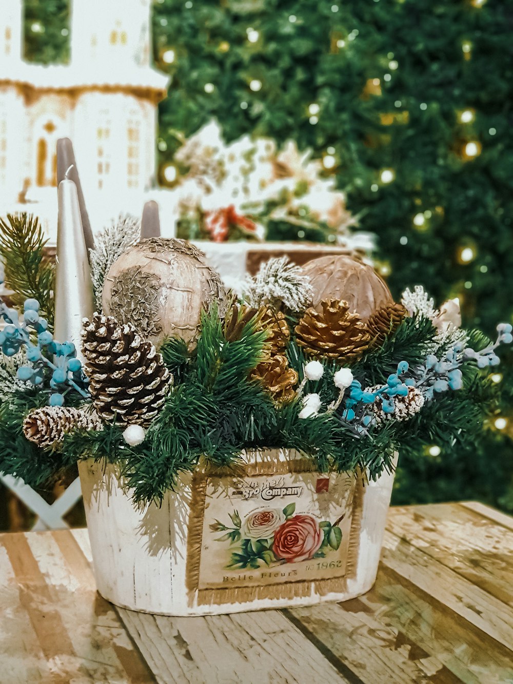brown pinecones and Christmas decors in white and brown bucket on wooden table