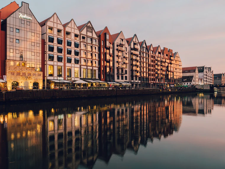 Historic buildings reflected in the water at Gdańsk