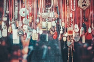 An assortment of necklaces arranged artistically on a wooden table.