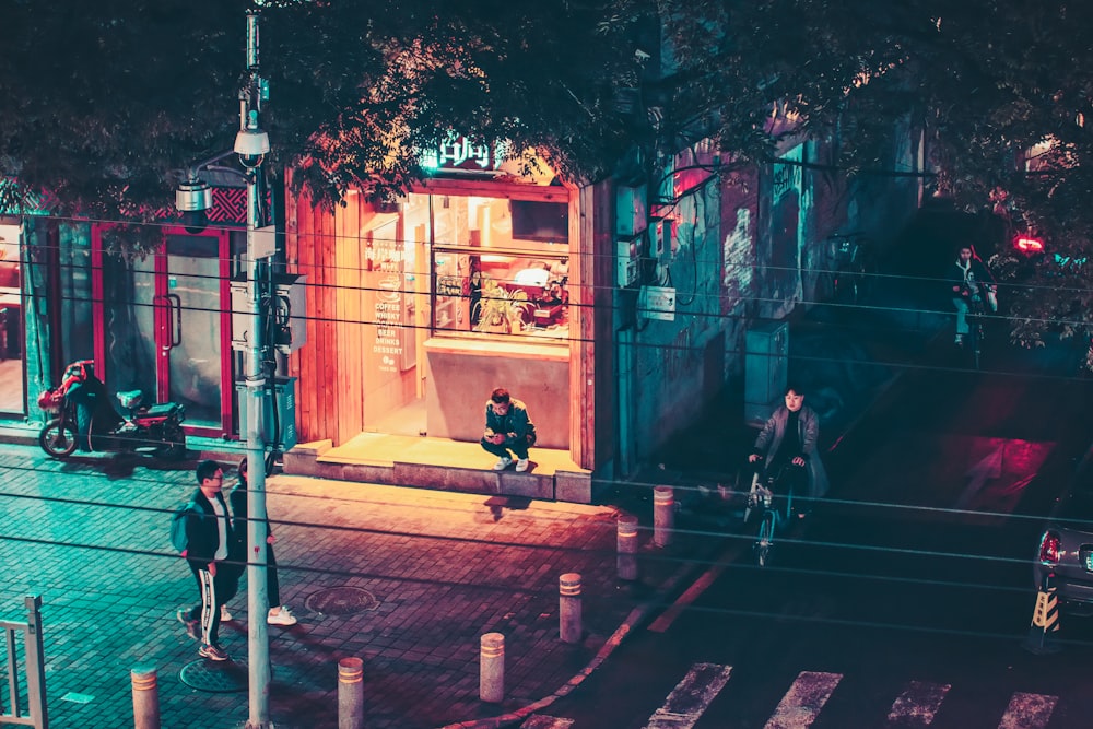 people walking beside post at night