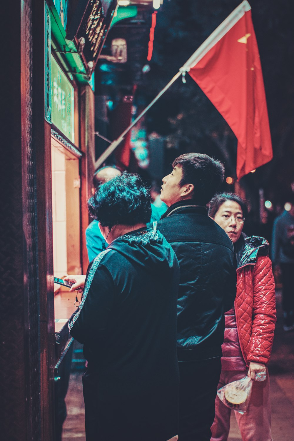 a group of people standing outside of a store