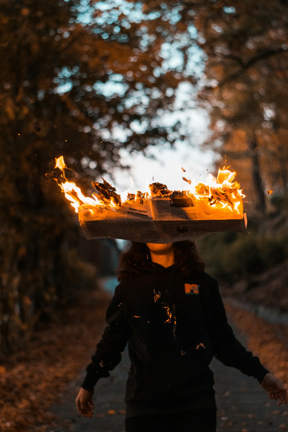 woman's head covered with burning box