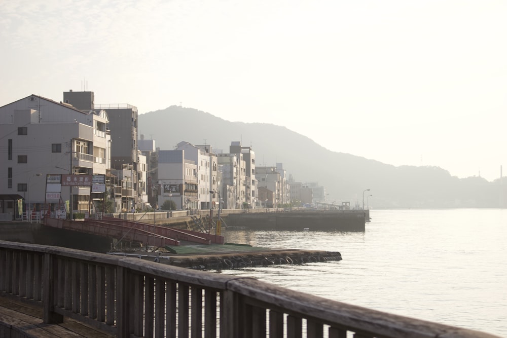 body of water beside buildings during daytime