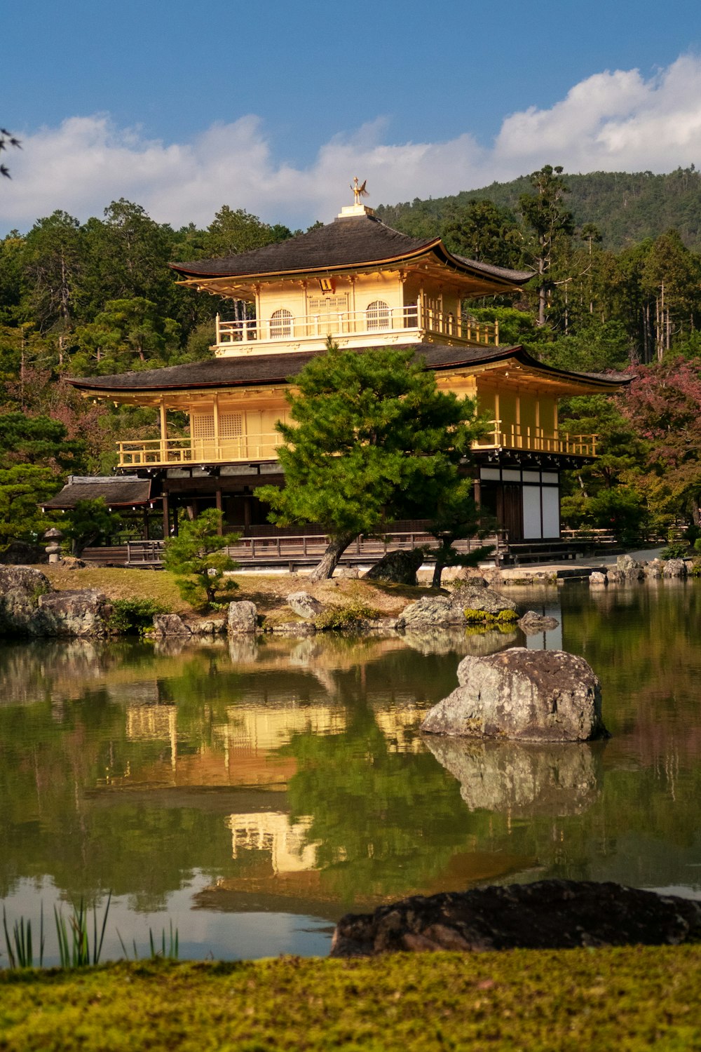 temple beside body of water during daytime