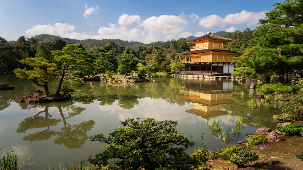 temple above water near trees during day