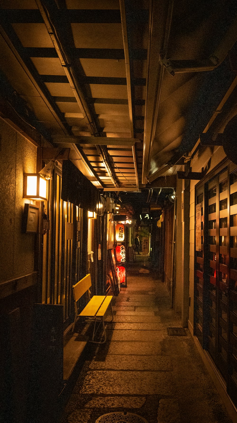 narrow pathway lighted with sconces