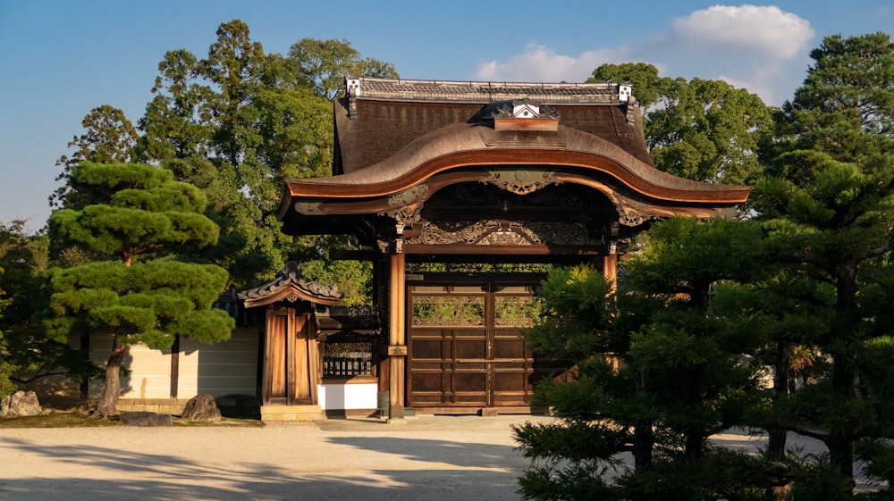 brown wooden pagoda gate surrounded by green trees