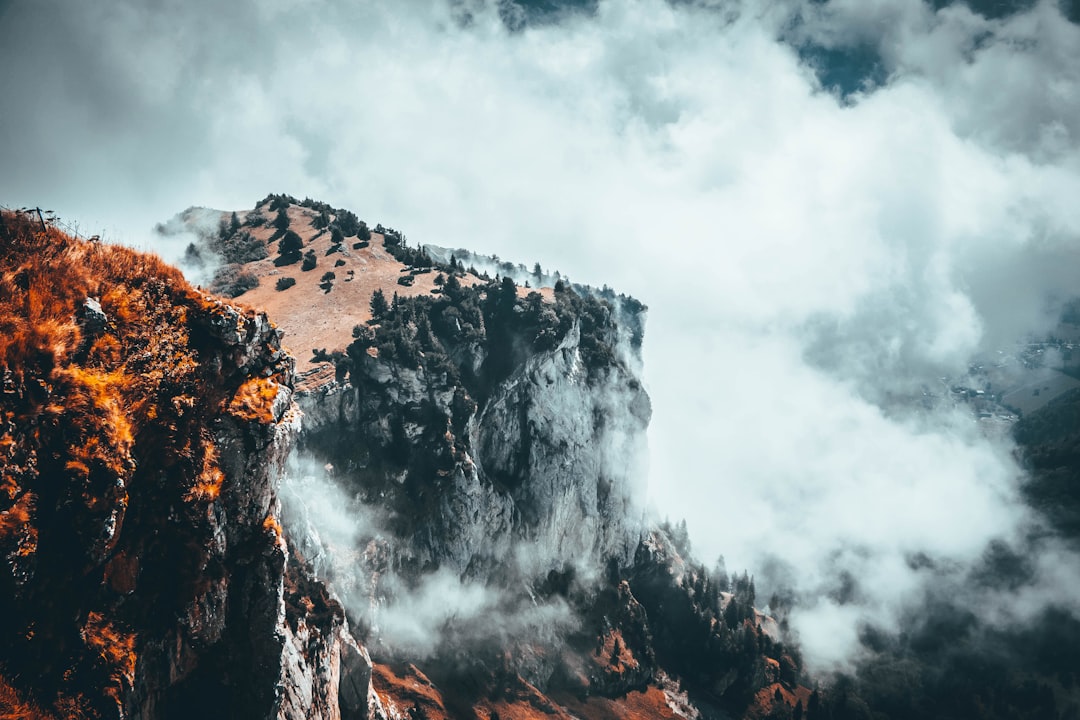 gray mountain under cloudy sky during daytime