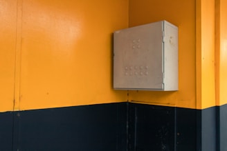 Close-up of a sleek sheet metal distribution box with mounting brackets.