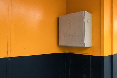 Close-up of a sleek sheet metal distribution box with mounting brackets.