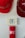 A set of red hard hats is mounted on a wall above an emergency alarm system. The alarm consists of a button to break glass in case of emergency and a red panel beneath it.