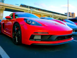 A bright red sports car gleaming under Nairobi’s clear blue sky.